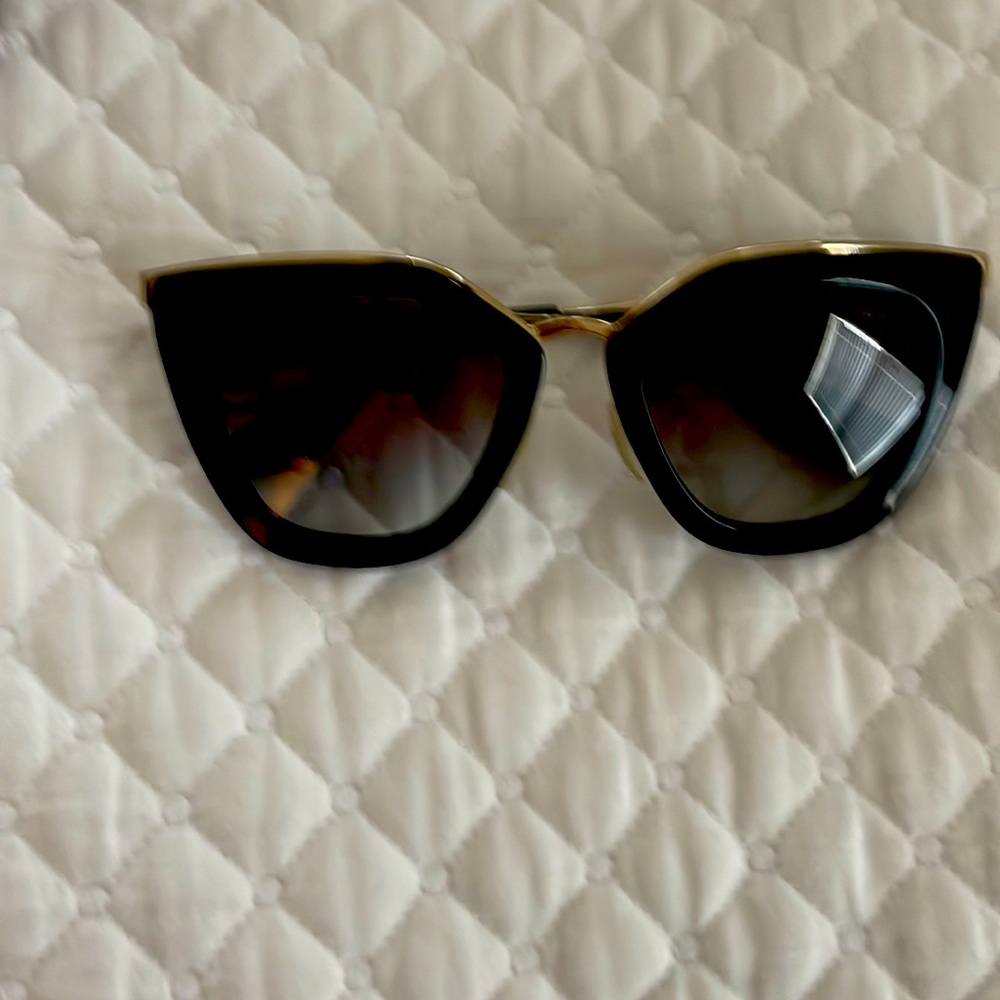 Black and gold Prada sunglasses.